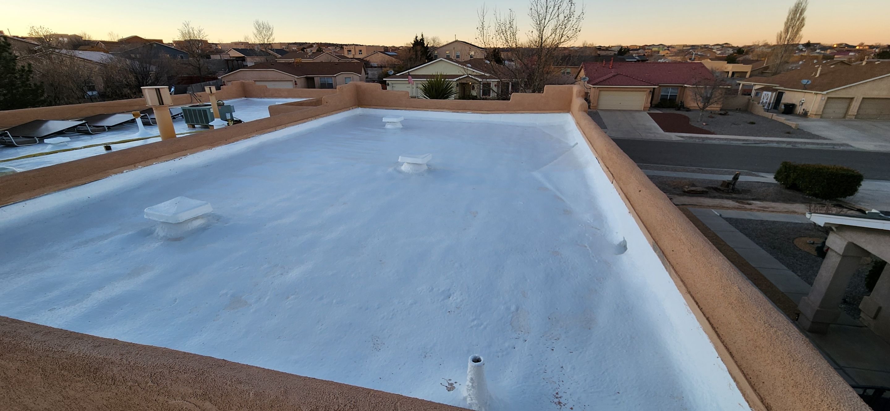 Modified bitumen roof with spray foam and silicone installation in Rio Rancho, New Mexico